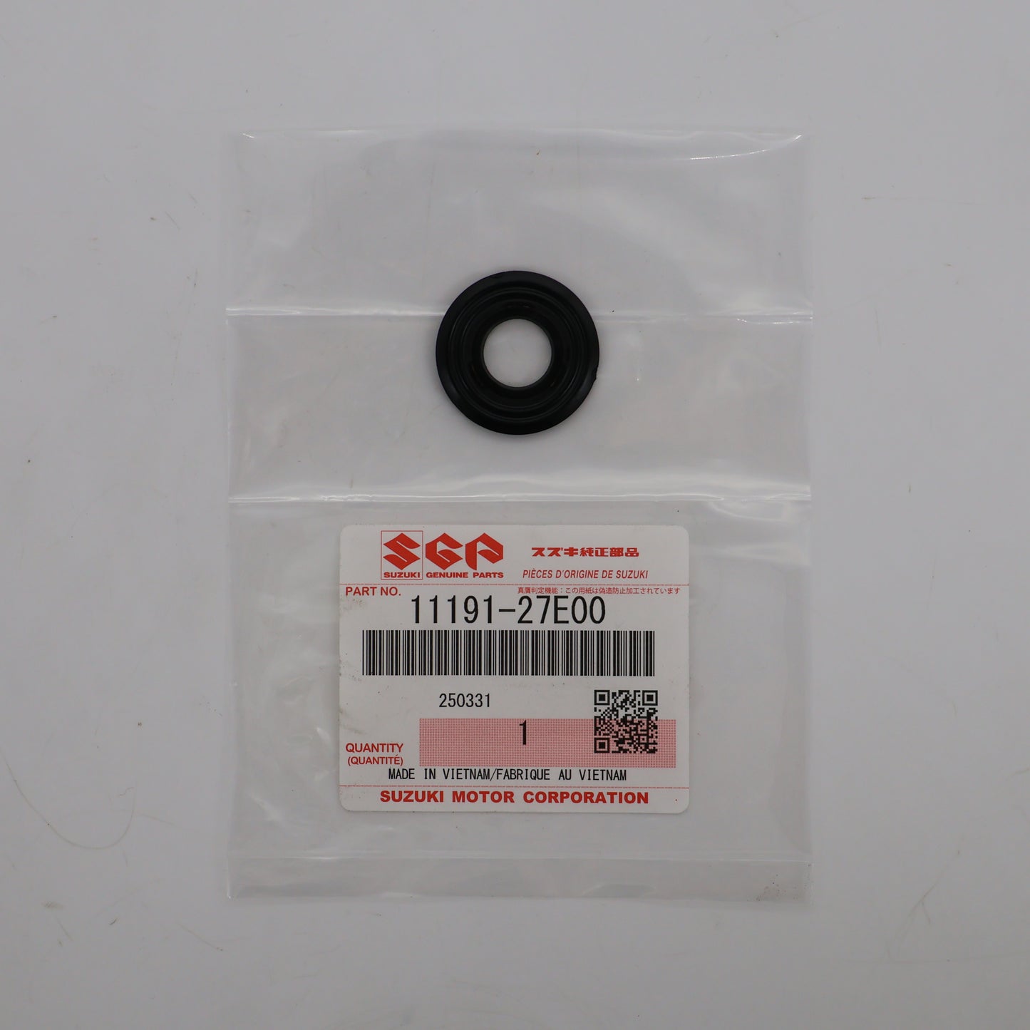Black rubber washer in a clear plastic bag with a Suzuki label on a white background