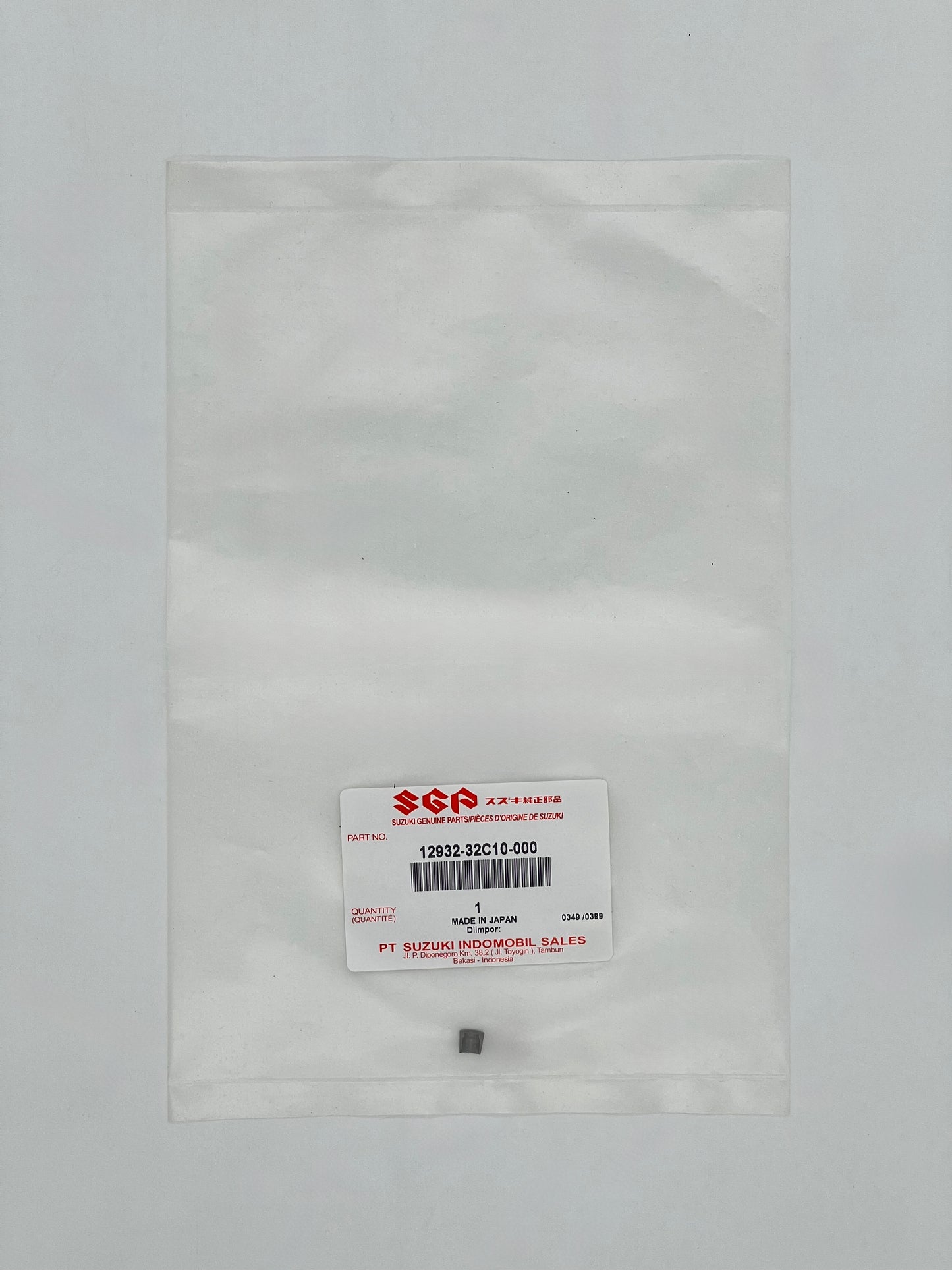 Small metal component in a clear plastic bag with SGA label on a gray background