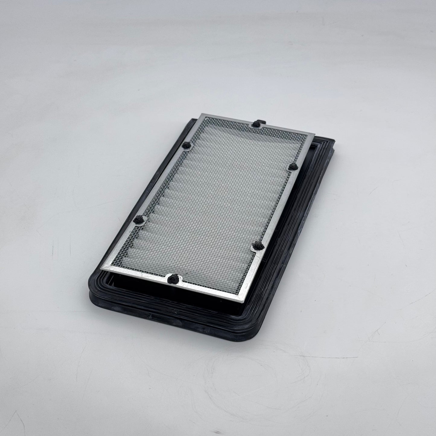 Rectangular metal filter on a gray background