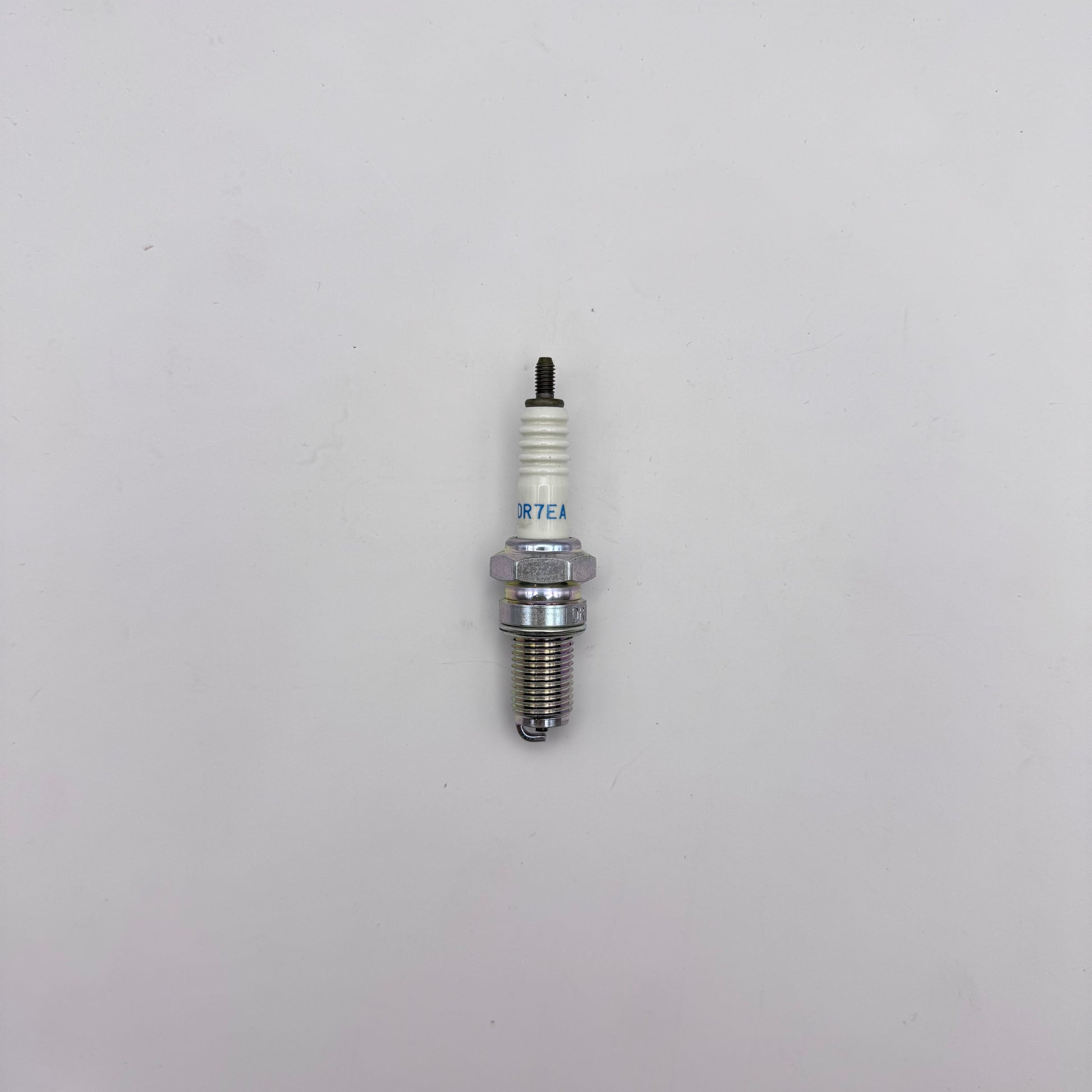 Spark plug on a light gray background