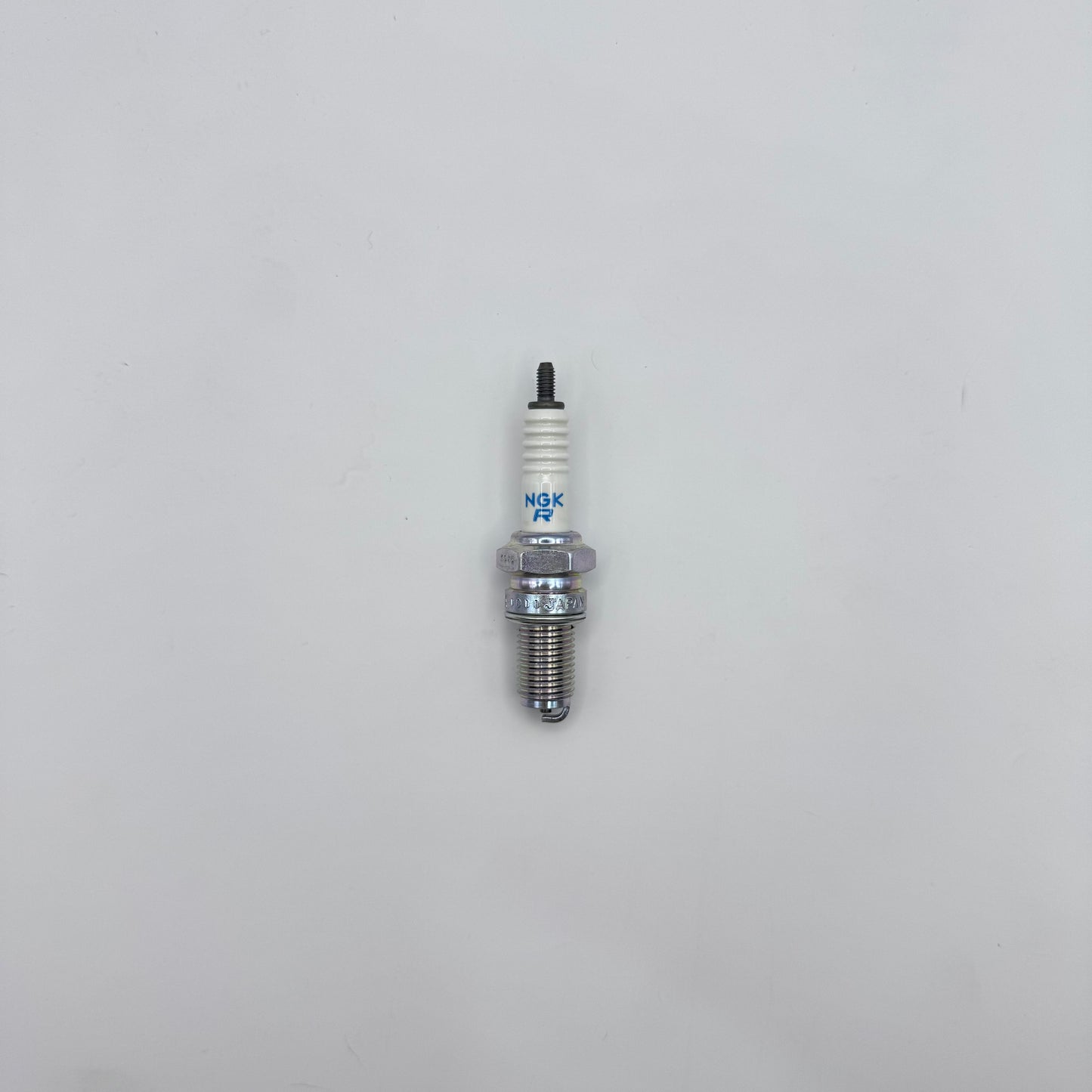 Spark plug on a light gray background