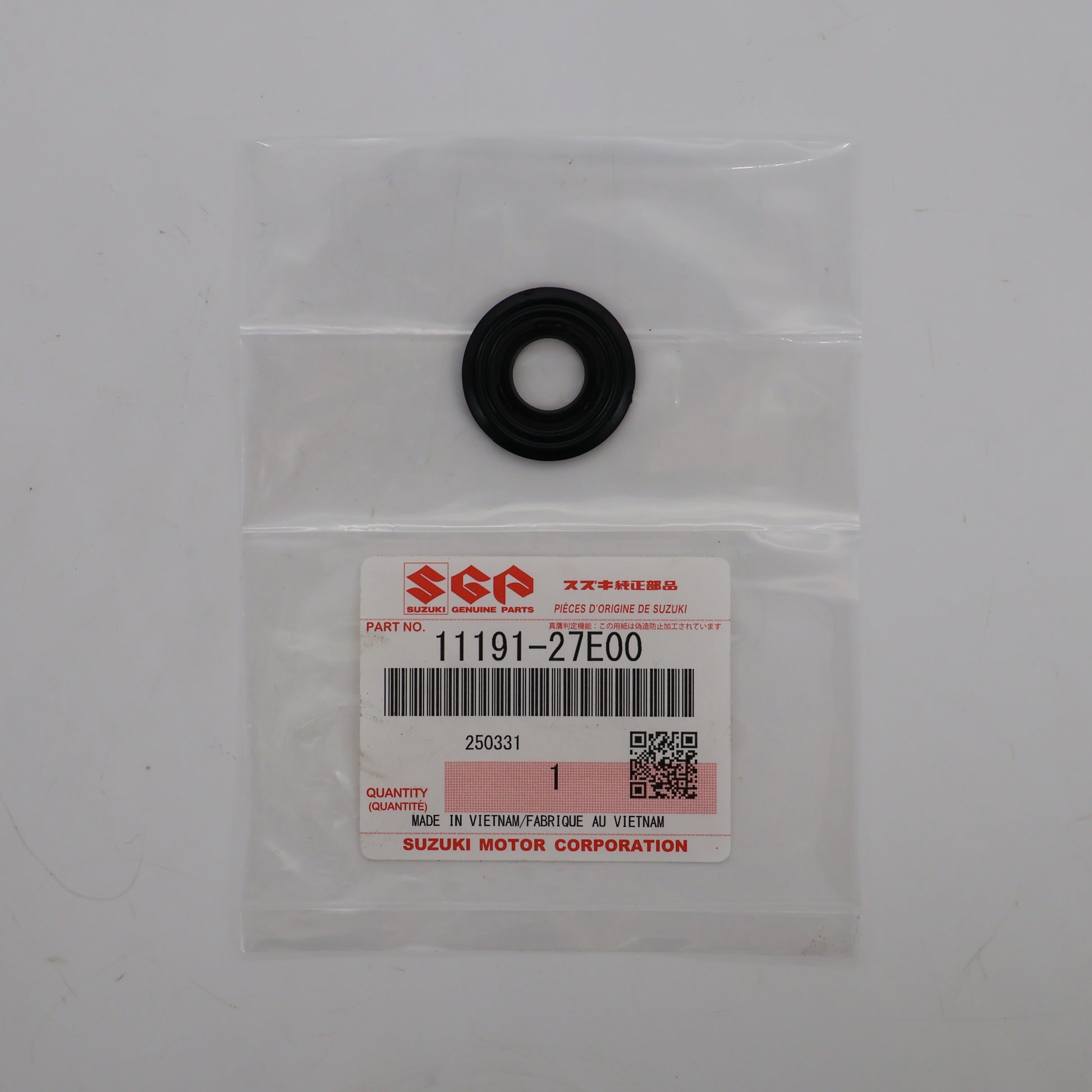 Black rubber washer in a clear plastic bag with a Suzuki label on a white background