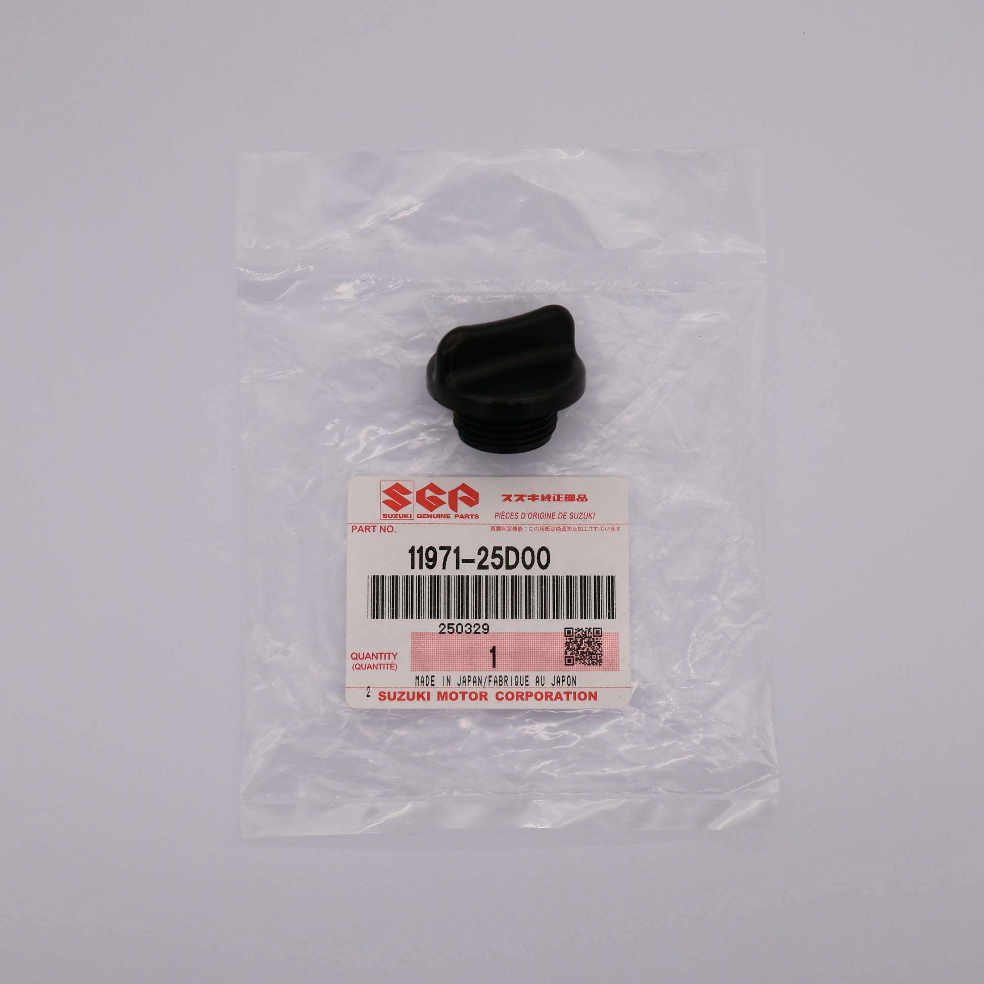 Black rubber part in clear packaging with Suzuki label on a gray background