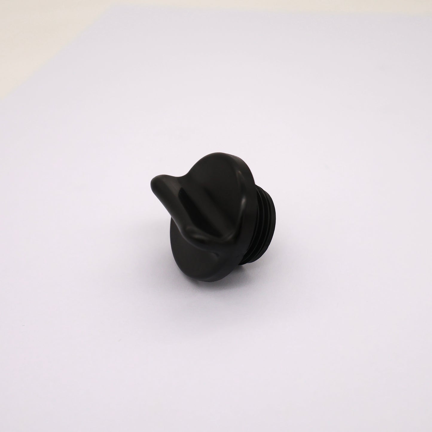 Black plastic knob on a white background