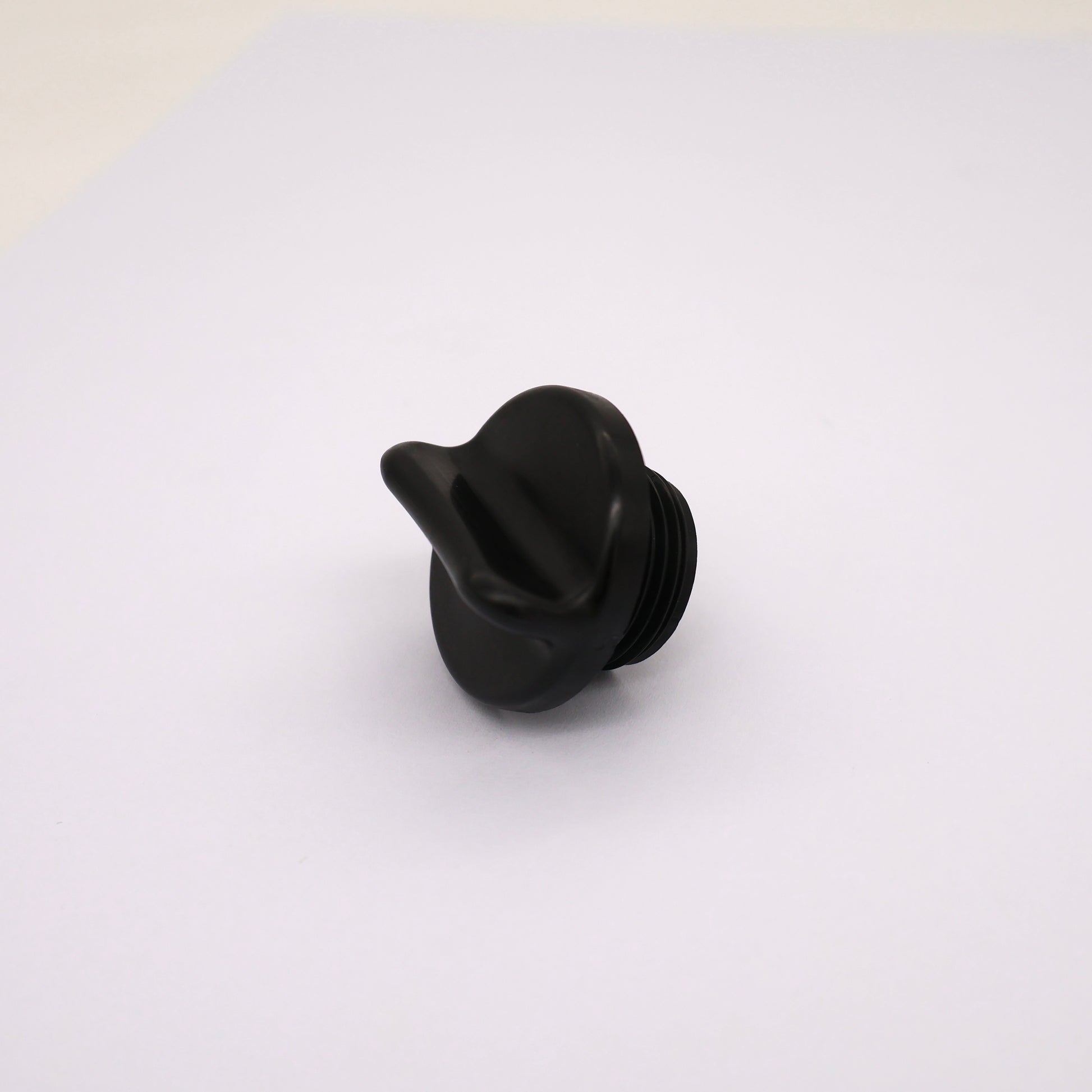 Black plastic knob on a white background
