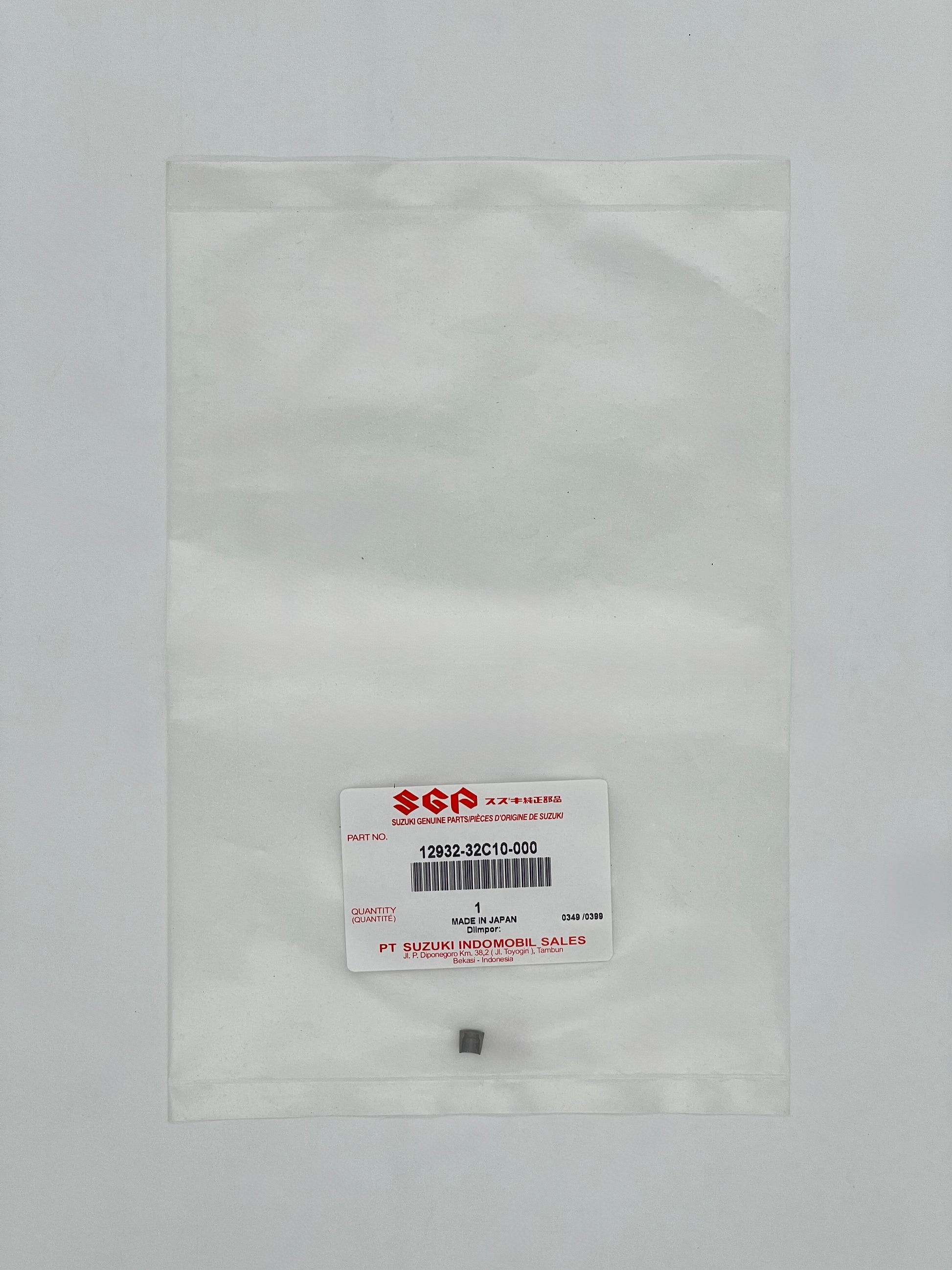 Small metal component in a clear plastic bag with SGA label on a gray background