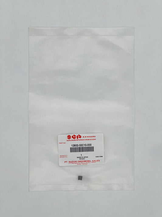 Small metal component in a clear plastic bag with SGA label on a gray background