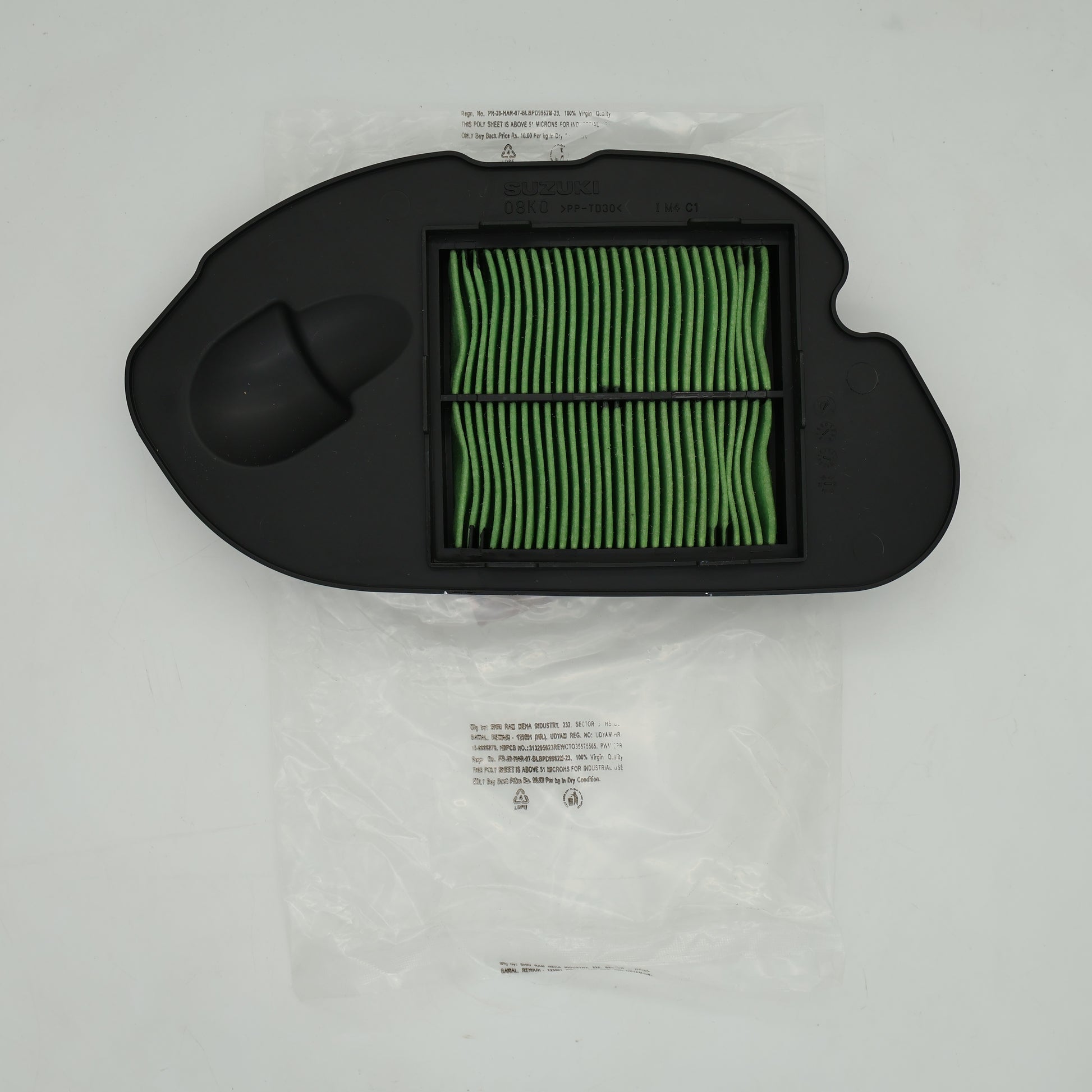 Car air filter with green pleated media on a white background