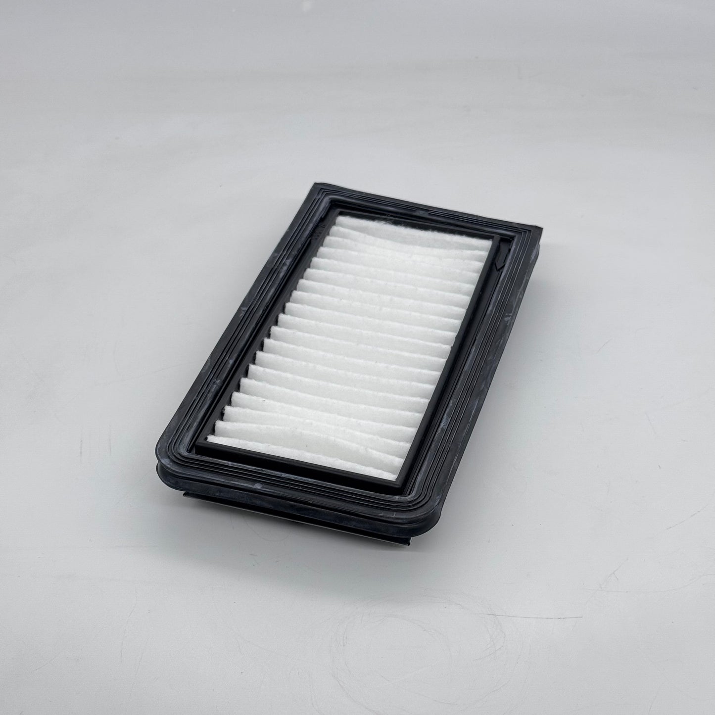 Car air filter on a gray background