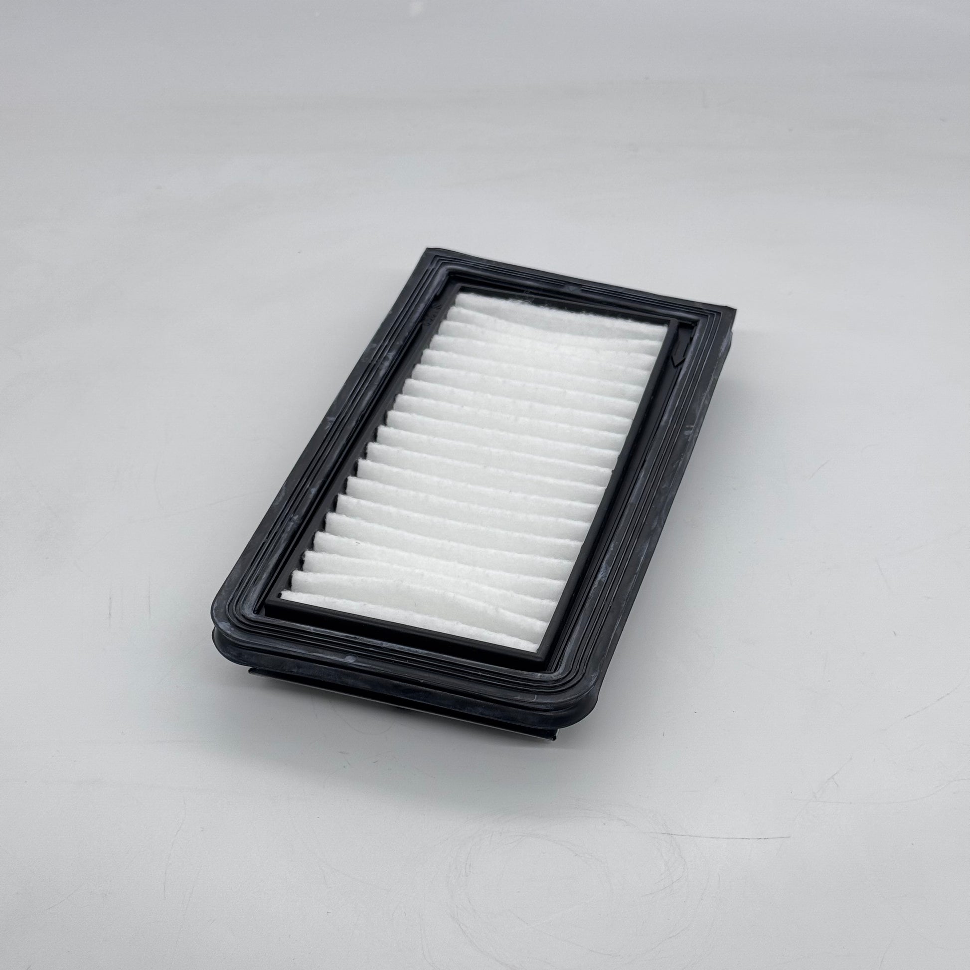 Car air filter on a gray background