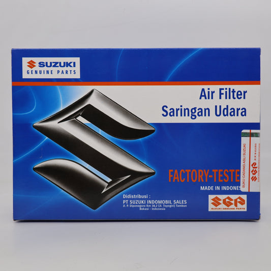 Suzuki genuine air filter packaging box, featuring a blue background with a large black stylized Suzuki logo and text reading 'Air Filter Saringan Udara' and 'Factory-Teste'.