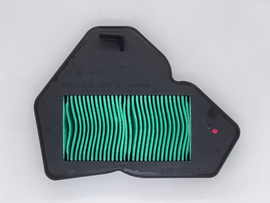 Green air filter in a black housing on a white background
