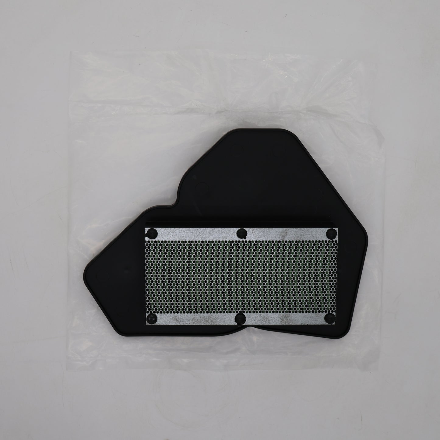 A black plastic automotive part with a silver metal mesh filter section, shown inside a clear plastic protective bag on a light gray background.