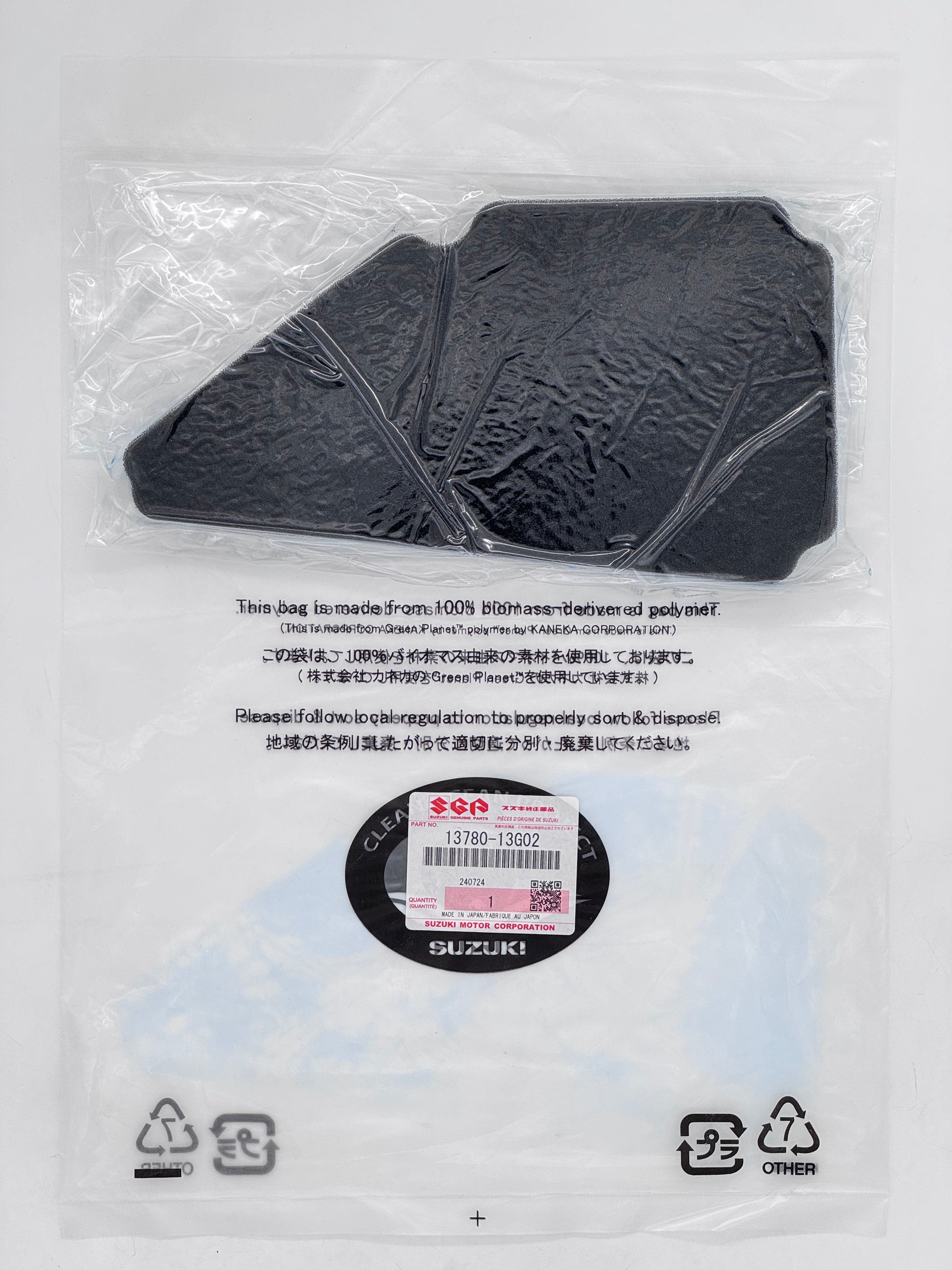 Black plastic component in clear packaging with branding and recycling symbols.