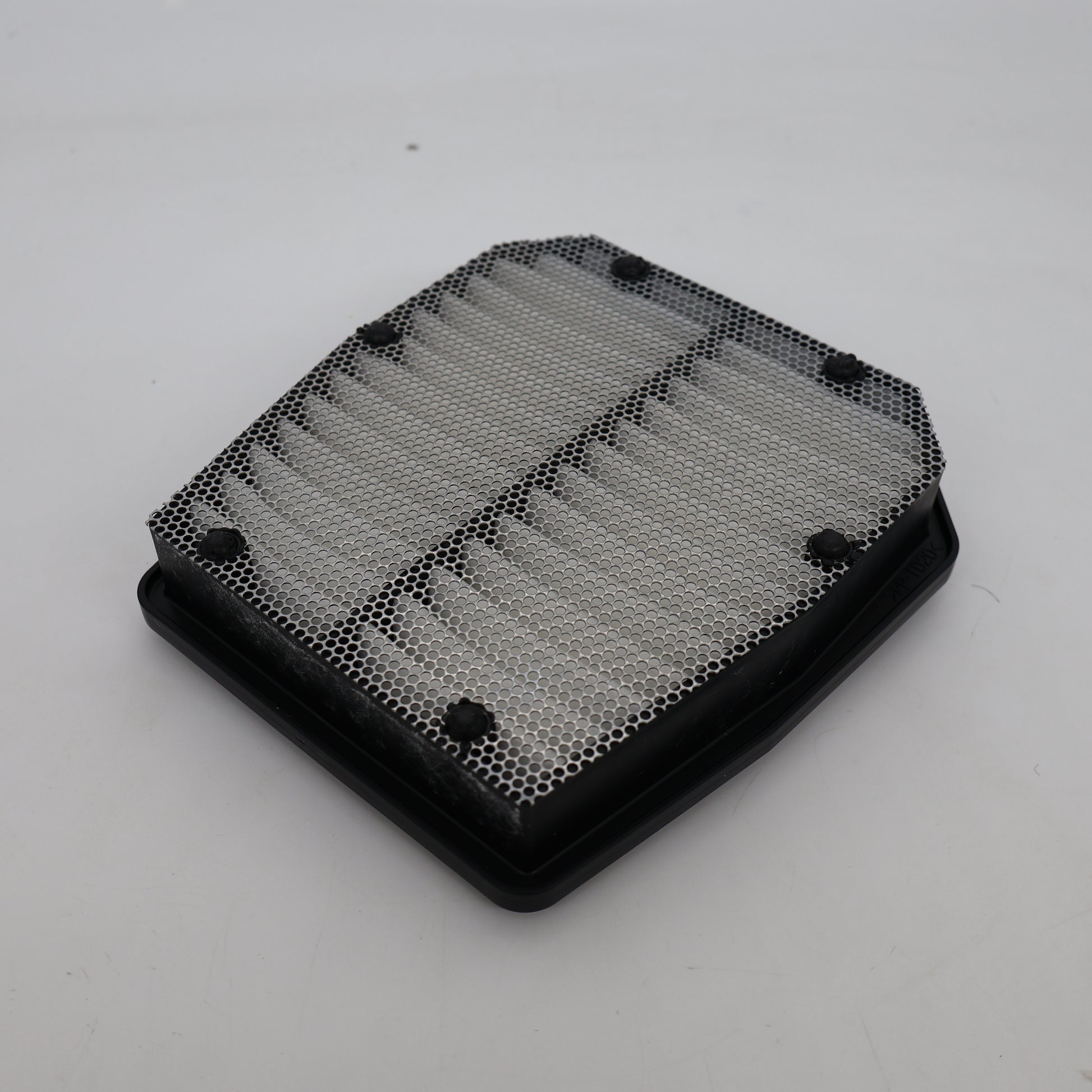 Black honeycomb filter on a white background