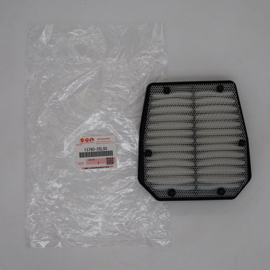 Black air filter next to its packaging on a gray background