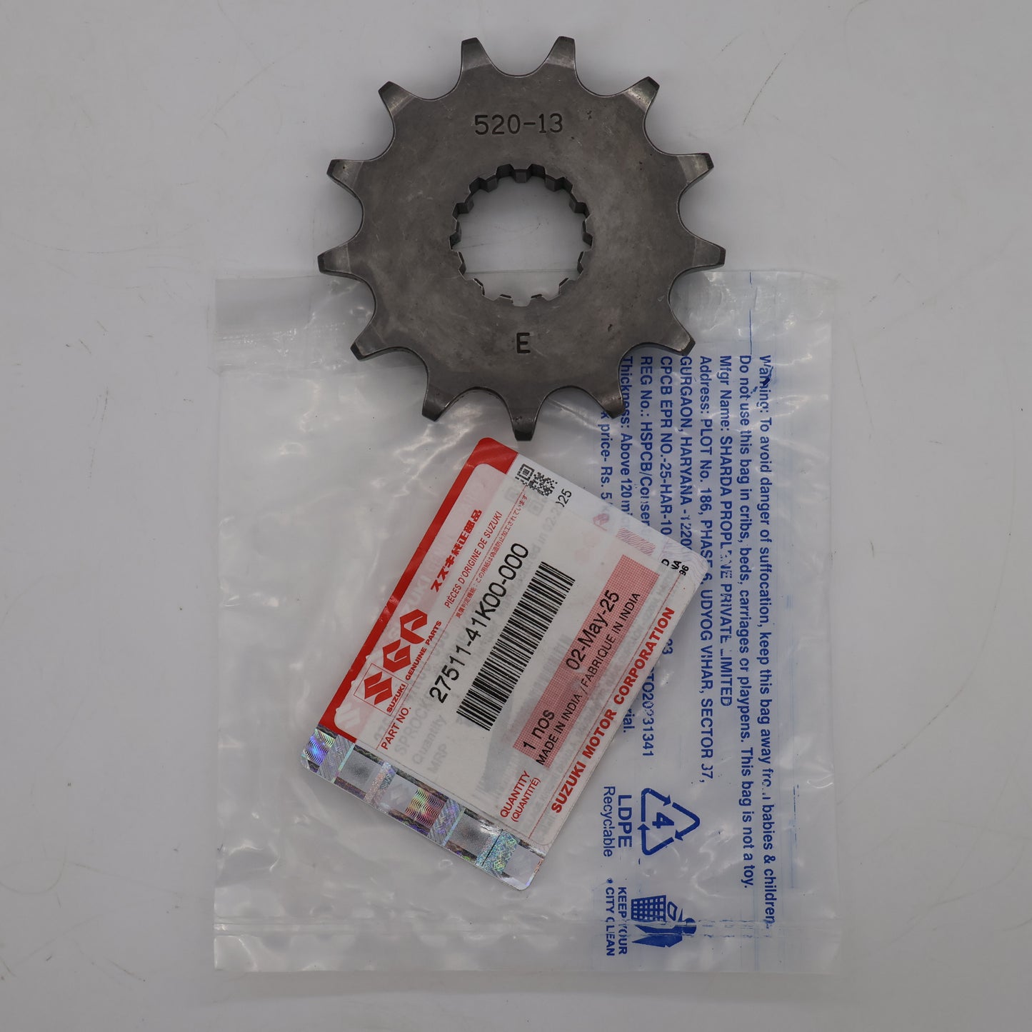 Metal sprocket with a label on a white background