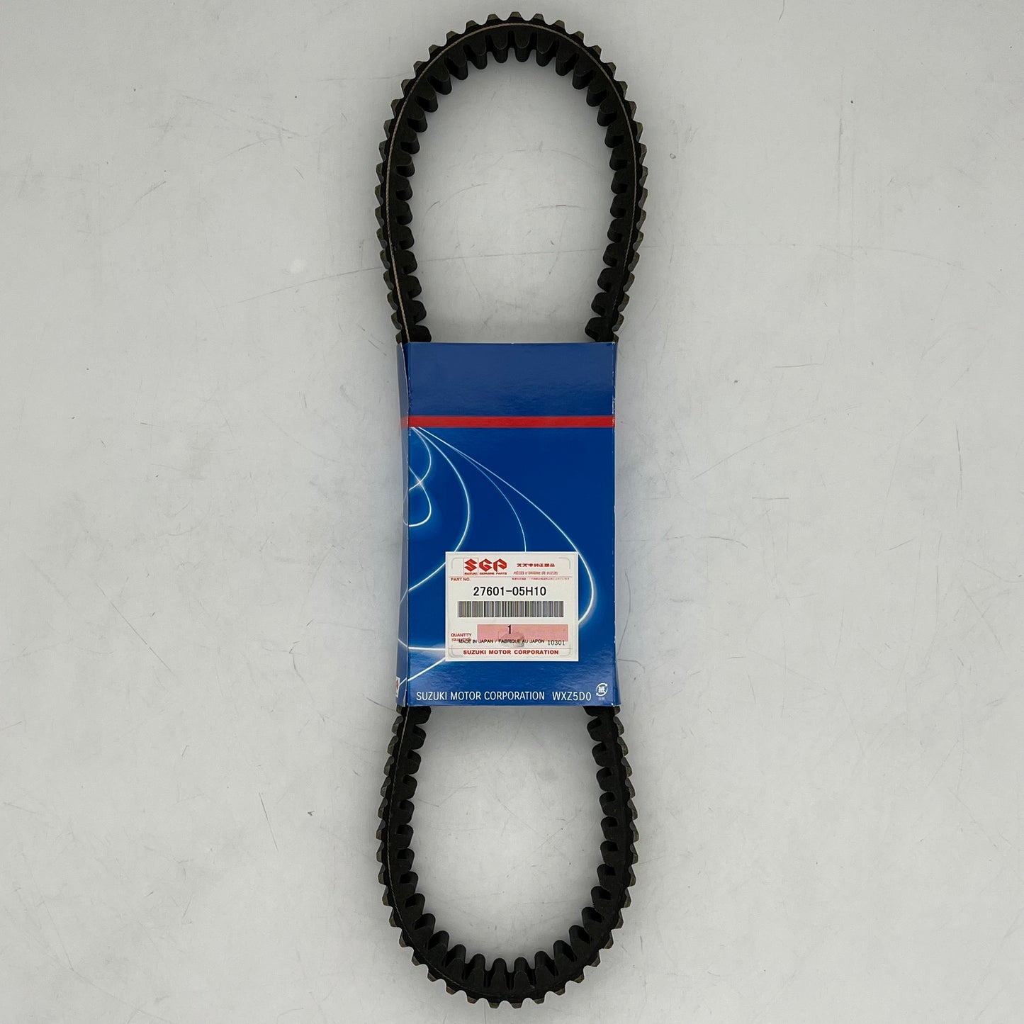 Black timing belt with a blue packaging label on a gray background