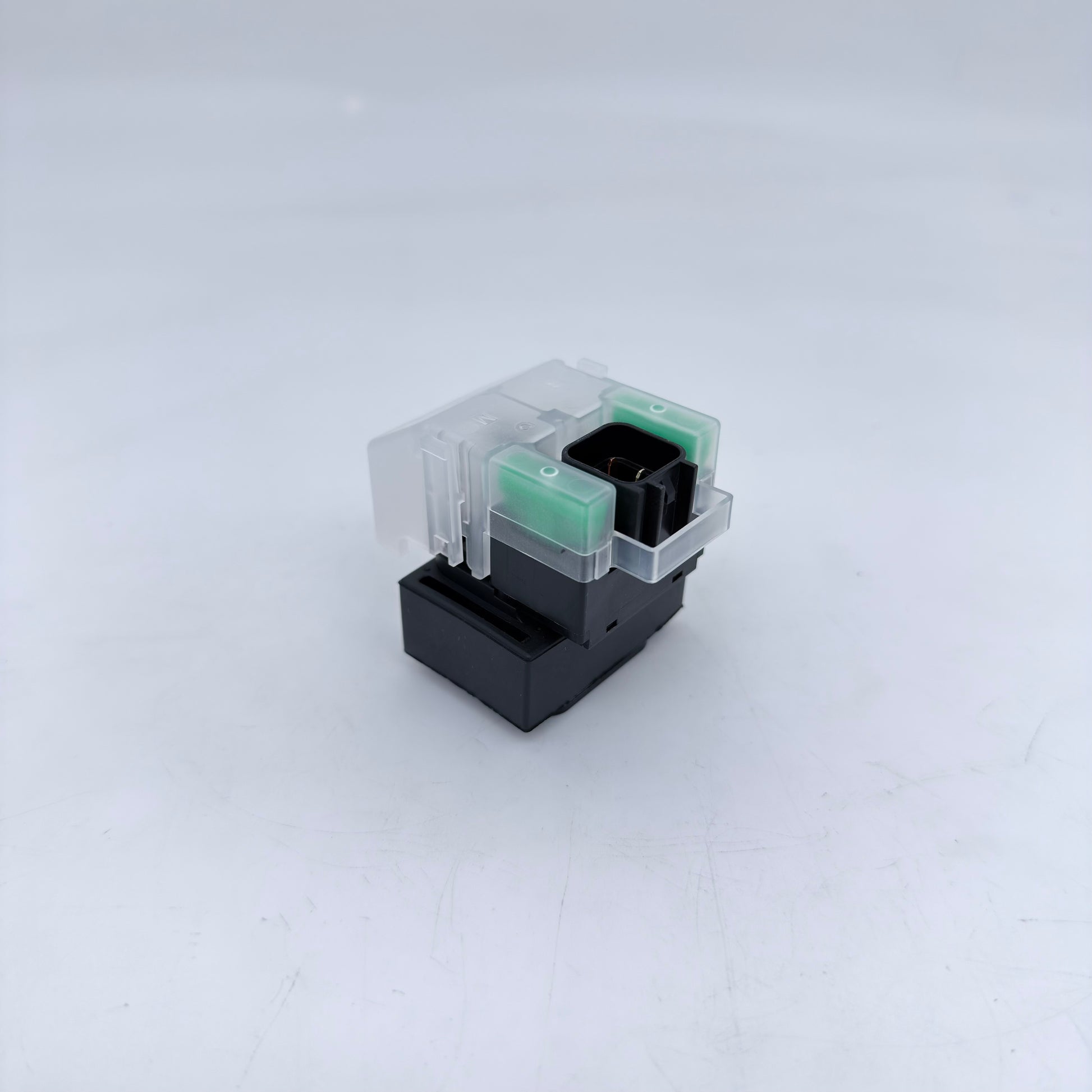 Small electronic component with clear and black parts on a white background