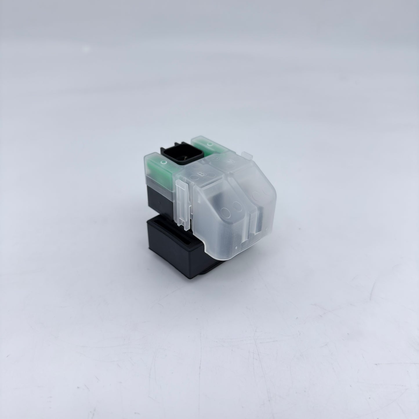 Clear and black printer ink cartridge on a white background