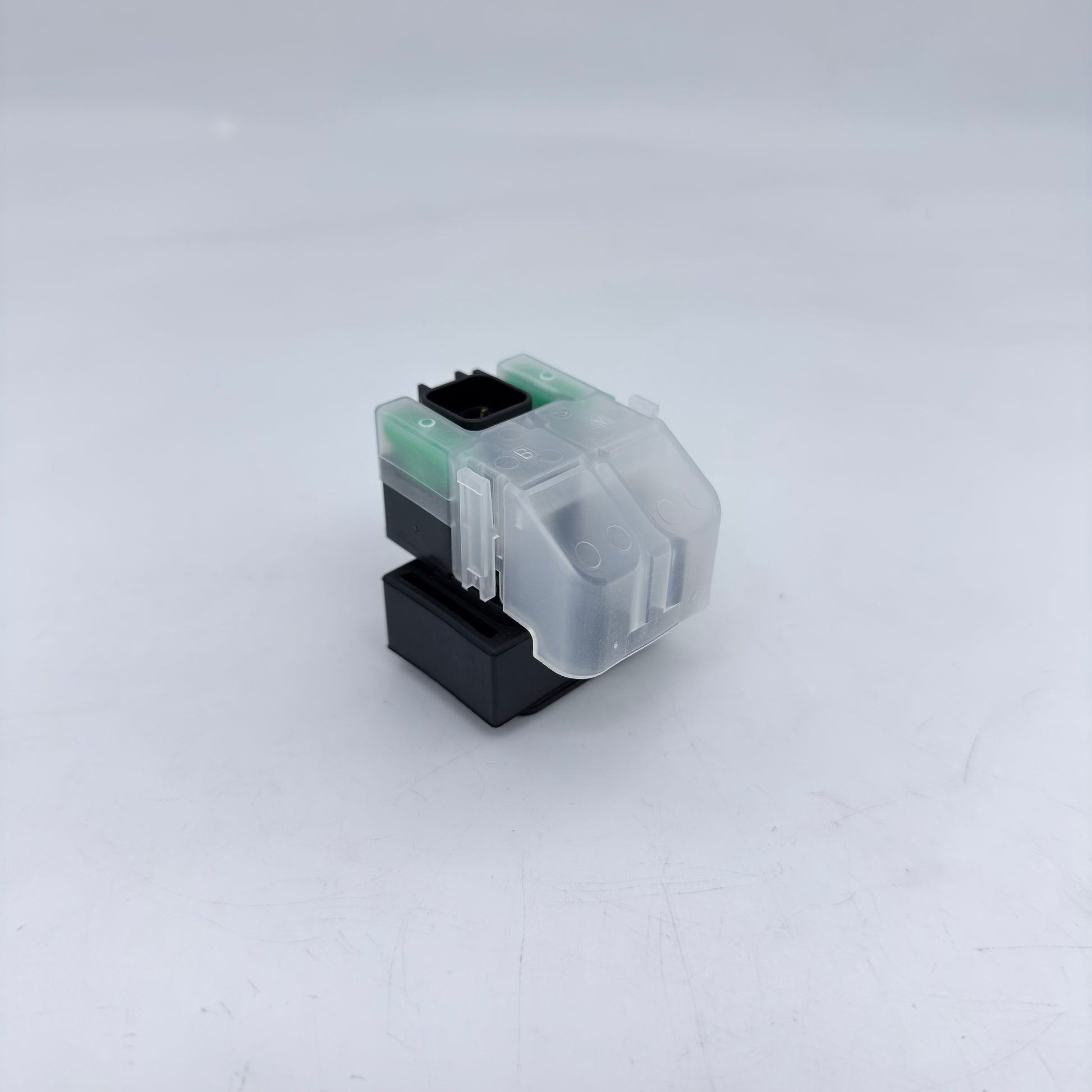 Clear and black printer ink cartridge on a white background