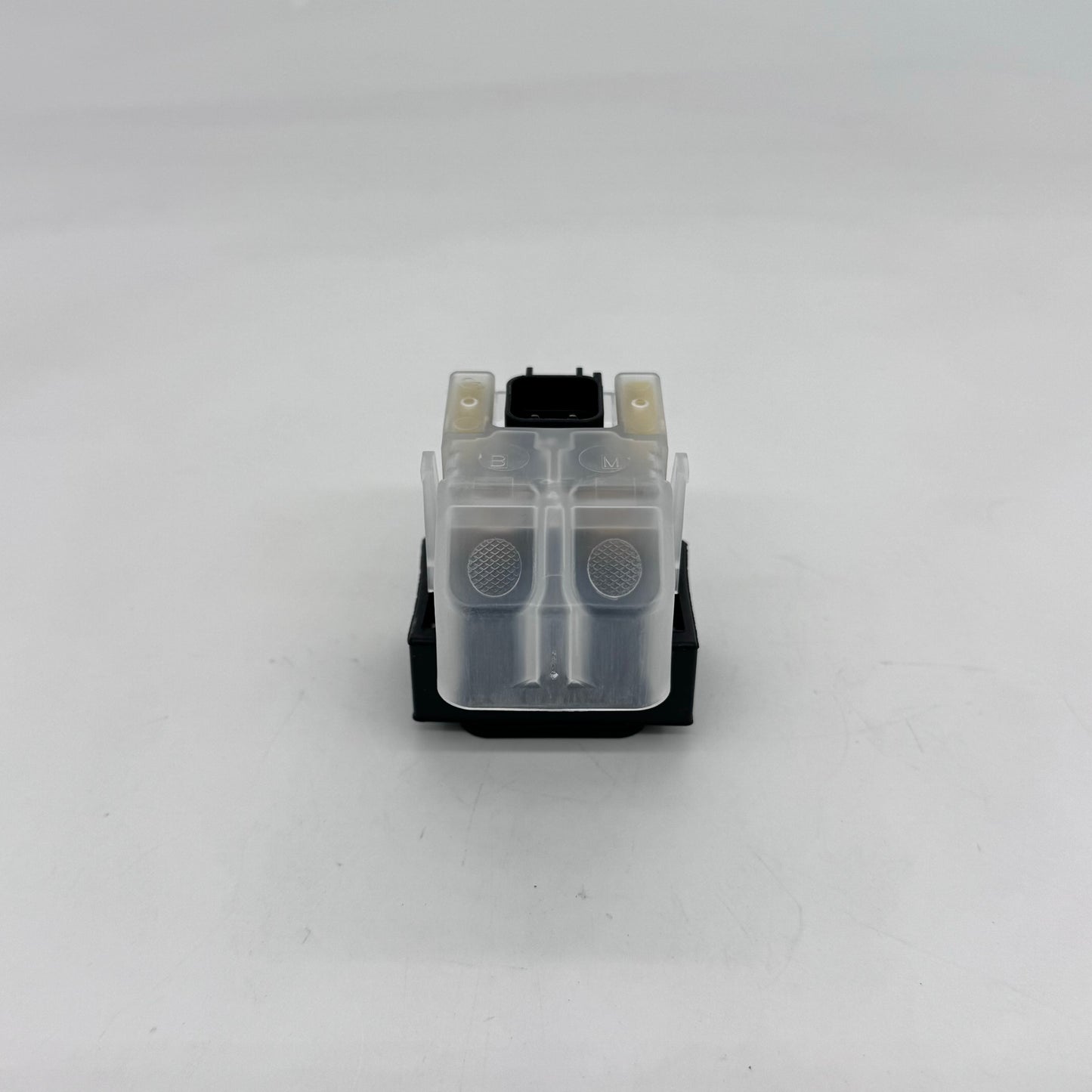 Small mechanical component with a clear plastic part on a white background
