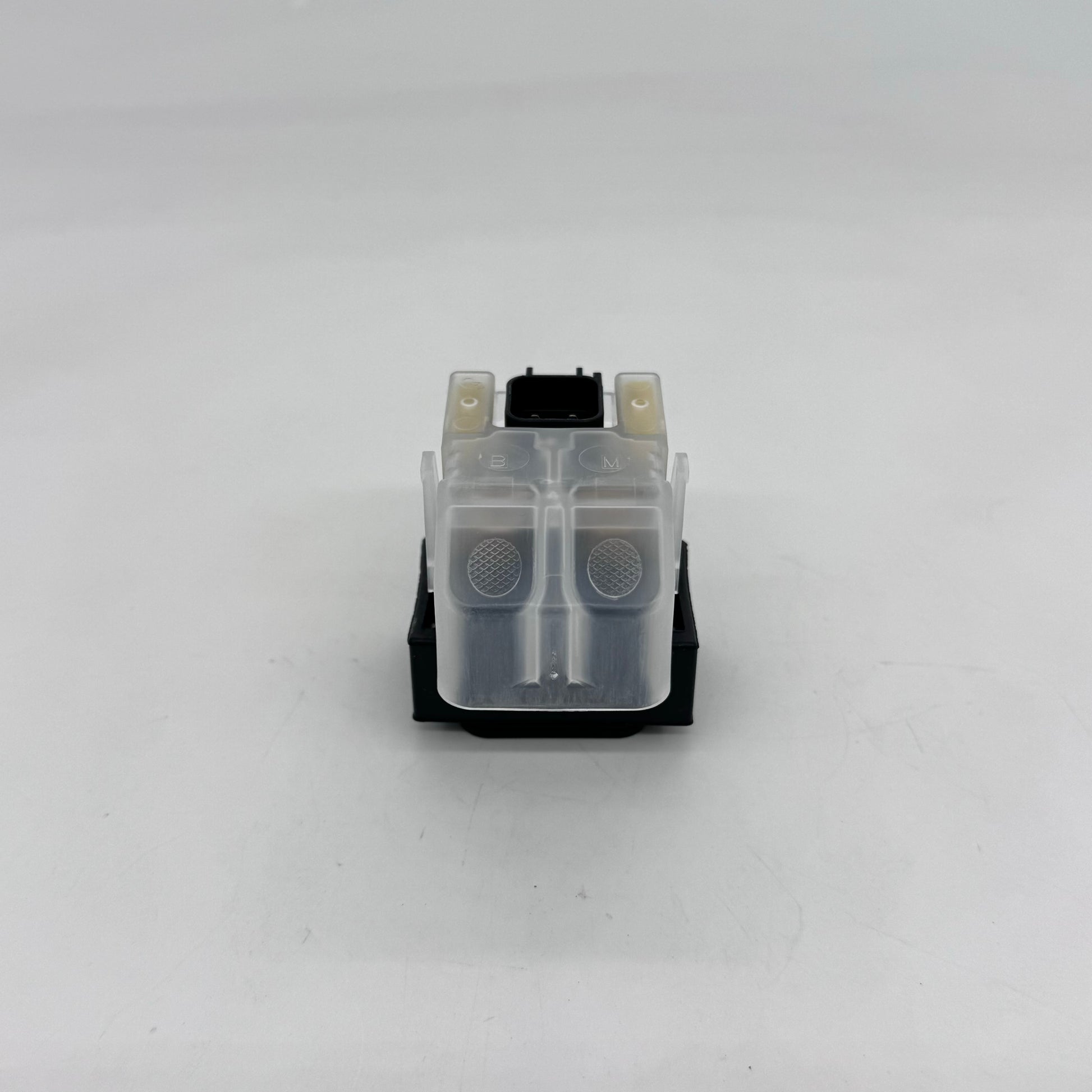 Small mechanical component with a clear plastic part on a white background