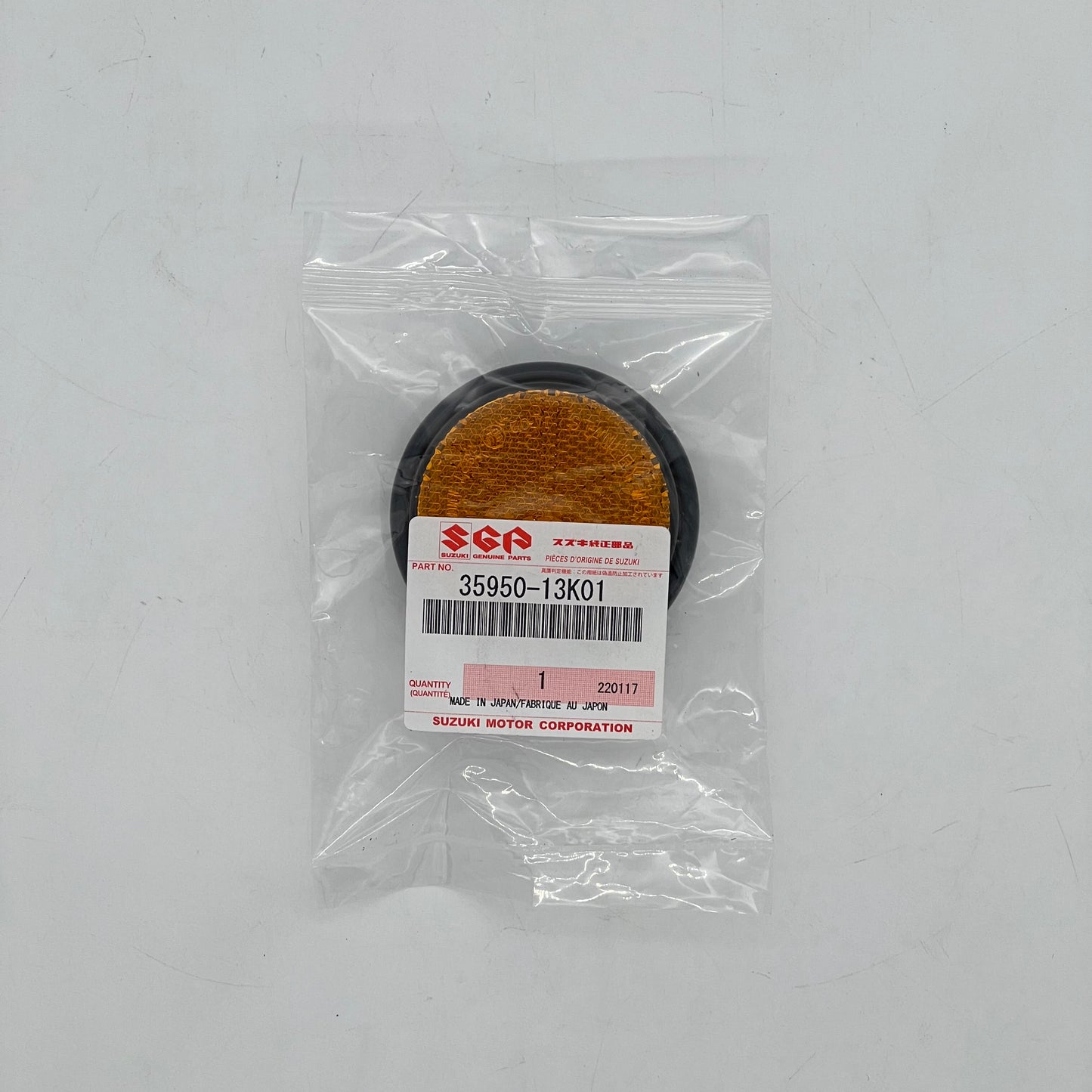 Suzuki part in a clear plastic bag on a white background