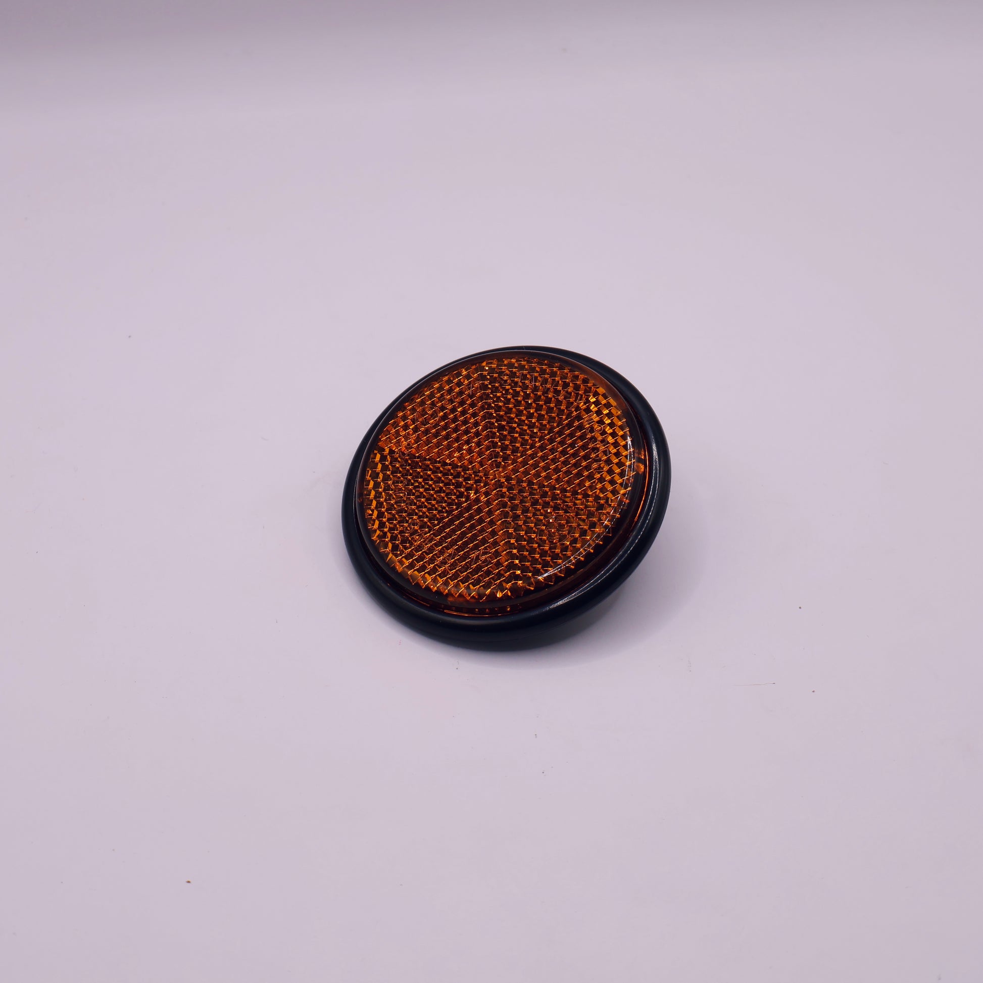 Round reflective sticker with brown mesh on a white background