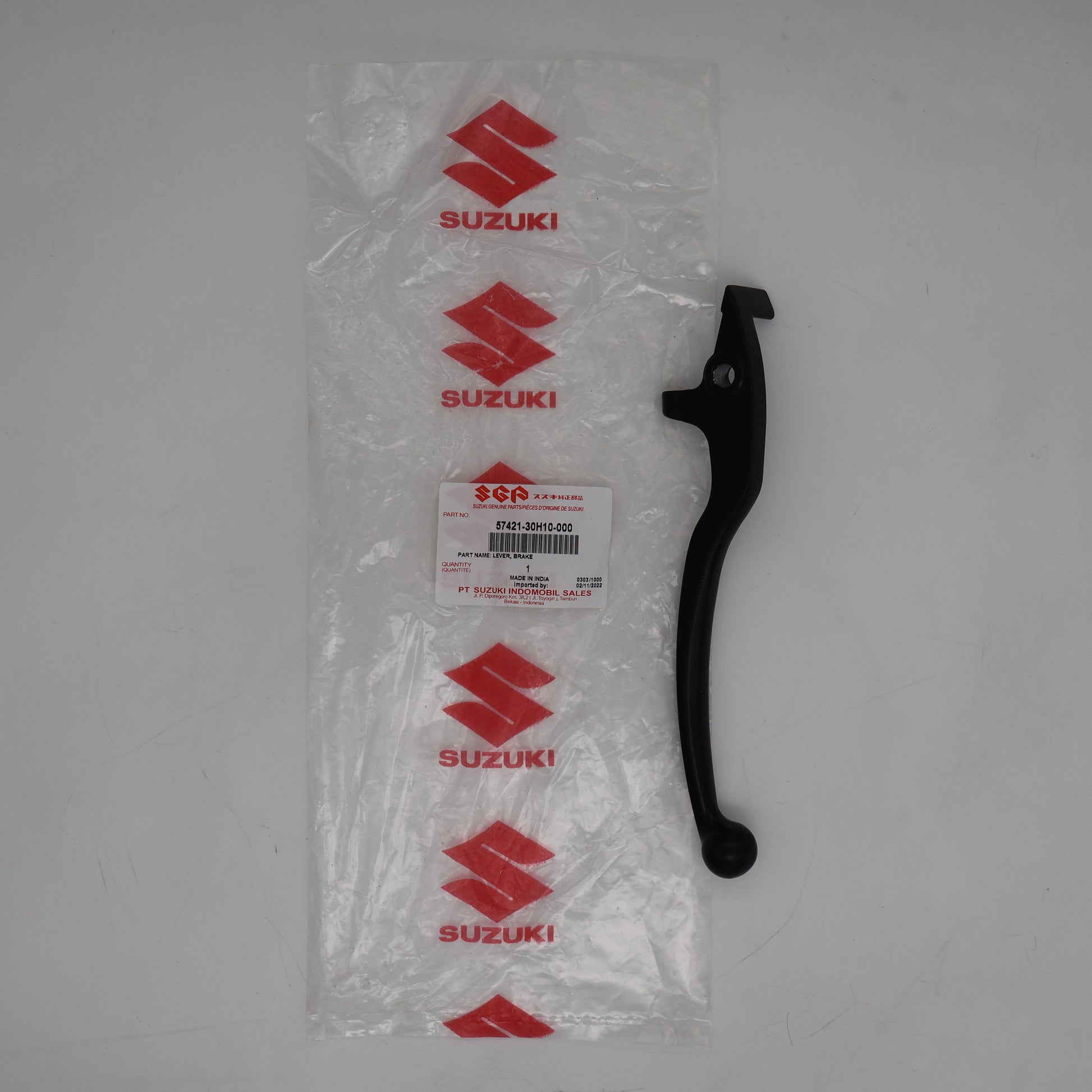Black Suzuki motorcycle lever on a white background with clear packaging.