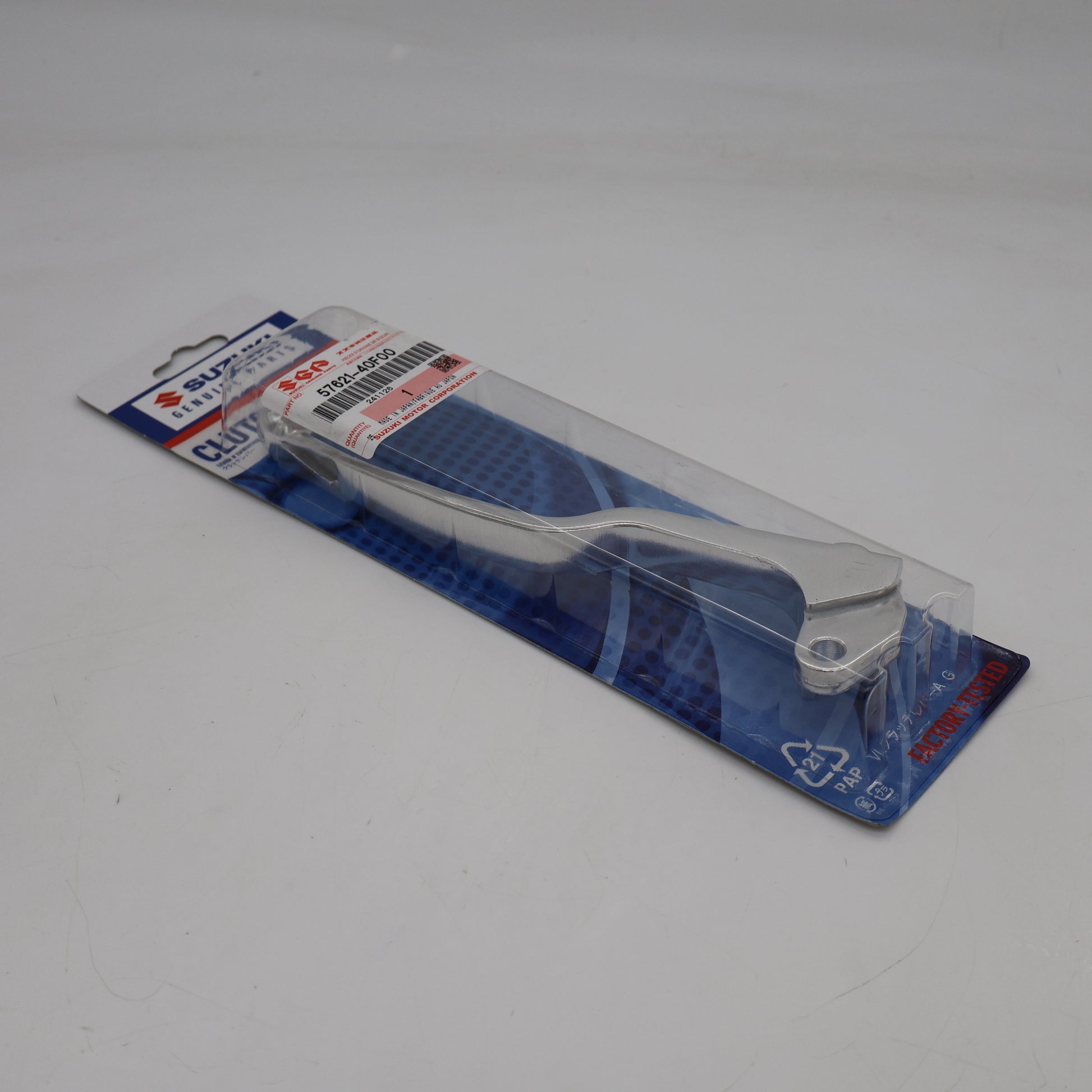 Metallic tool on a clear plastic stand with blue packaging on a white background